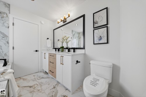 Full bathroom featuring double vanity and light marble finish floors - 9907 68 Street, Edmonton, AB - Indoor