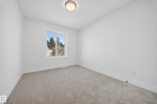 Empty room featuring baseboards and light colored carpet - 9907 68 Street, Edmonton, AB - Indoor Photo Showing Other Room