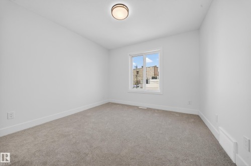 Spare room featuring light carpet and baseboards - 9907 68 Street, Edmonton, AB - Indoor Photo Showing Other Room