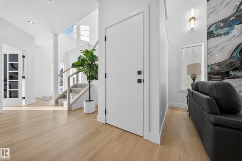 Foyer entrance with a high ceiling and light wood-style flooring - 9907 68 Street, Edmonton, AB - Indoor Photo Showing Other Room
