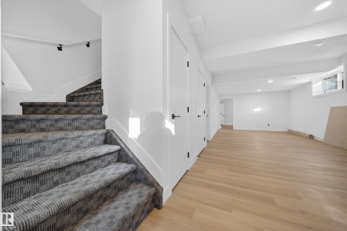 Stairs with recessed lighting and wood finished floors - 9907 68 Street, Edmonton, AB - Indoor Photo Showing Other Room