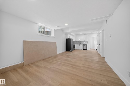 Unfurnished living room with light wood-style floors and recessed lighting - 9907 68 Street, Edmonton, AB - Indoor Photo Showing Other Room