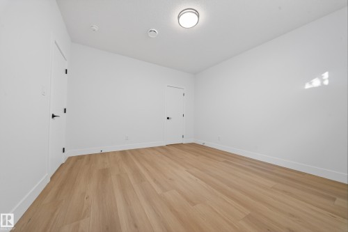 Empty room featuring light wood-style flooring and baseboards - 9907 68 Street, Edmonton, AB - Indoor Photo Showing Other Room