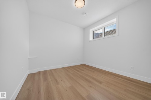 Spare room featuring baseboards and light wood-style floors - 9907 68 Street, Edmonton, AB - Indoor Photo Showing Other Room