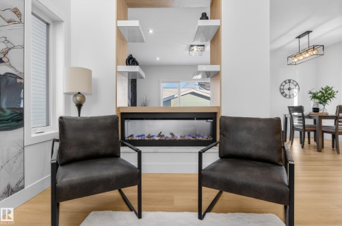 Sitting room with light wood-style flooring - 9907 68 Street, Edmonton, AB - Indoor With Fireplace