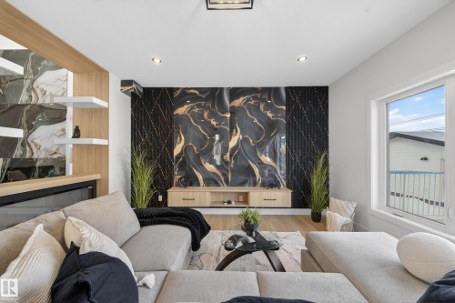 Sitting room featuring an accent wall, wood finished floors, and recessed lighting - 9907 68 Street, Edmonton, AB - Indoor Photo Showing Living Room