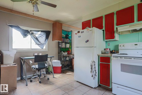 Kitchen with white appliances, ceiling fan, light tile patterned flooring, an office area, and bold wood finish cabinets - 19 Ridgeway Drive Nw, Edmonton, AB - Indoor Photo Showing Kitchen