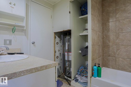 Full bathroom featuring vanity, water heater, and shower / tub combo - 19 Ridgeway Drive Nw, Edmonton, AB - Indoor Photo Showing Bathroom