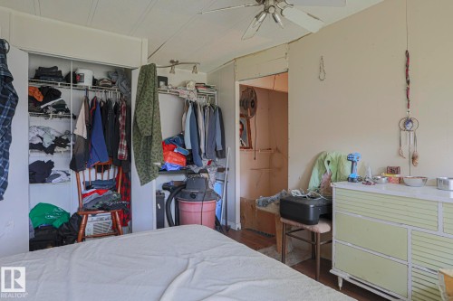 Bedroom with a closet, dark wood-style floors, and ceiling fan - 19 Ridgeway Drive Nw, Edmonton, AB - Indoor Photo Showing Bedroom