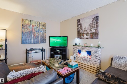 402A 2908 116A Avenue, Edmonton, AB - Indoor Photo Showing Other Room With Fireplace