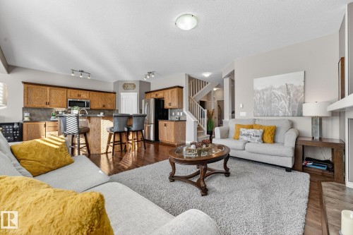 Living area featuring dark wood finished floors and a textured ceiling - 1734 63A Street, Edmonton, AB - Indoor Photo Showing Living Room