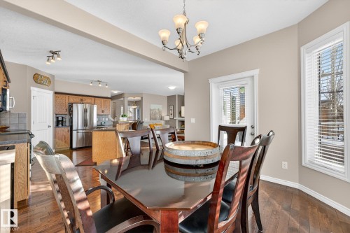 Dining area with dark wood-type flooring and suspended lighting - 1734 63A Street, Edmonton, AB - Indoor Photo Showing Dining Room