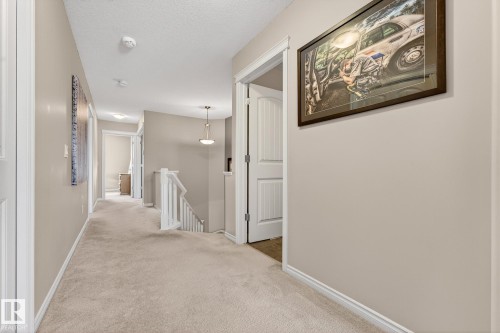 Hallway with an upstairs landing, carpet flooring, and a textured ceiling - 1734 63A Street, Edmonton, AB - Indoor Photo Showing Other Room