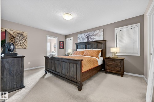 Bedroom featuring light colored carpet and ensuite bath - 1734 63A Street, Edmonton, AB - Indoor Photo Showing Bedroom
