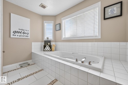 Bathroom featuring tile patterned floors and a bath - 1734 63A Street, Edmonton, AB - Indoor Photo Showing Bathroom