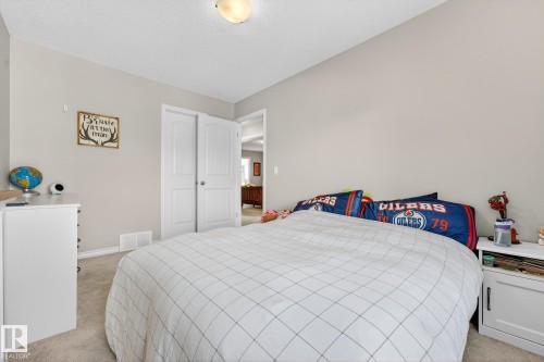 Bedroom with light colored carpet, a closet, and a textured ceiling - 1734 63A Street, Edmonton, AB - Indoor Photo Showing Bedroom