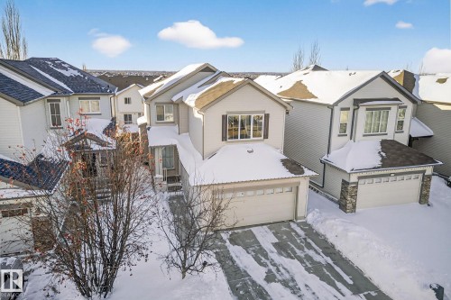 View of front facade with a garage and a residential view - 1734 63A Street, Edmonton, AB - Outdoor With Facade