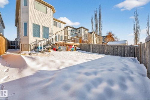 Rear view of house with a fenced backyard and a wooden deck - 1734 63A Street, Edmonton, AB - Outdoor