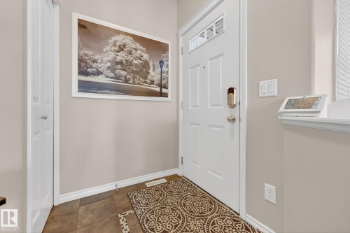 Tiled foyer entrance with baseboards - 1734 63A Street, Edmonton, AB - Indoor Photo Showing Other Room