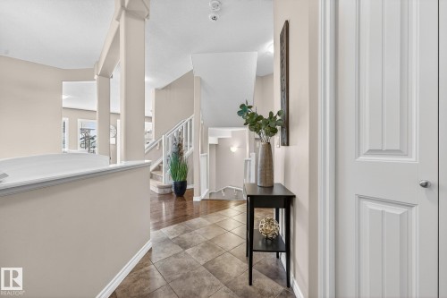 Hallway featuring stairway and tile patterned flooring - 1734 63A Street, Edmonton, AB - Indoor Photo Showing Other Room