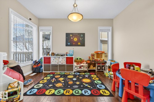 Rec room with healthy amount of natural light and dark wood-style flooring - 1734 63A Street, Edmonton, AB - Indoor Photo Showing Other Room