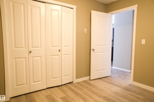 Unfurnished bedroom with light wood-style floors and a closet - 104 5804 Place Nw, Edmonton, AB - Indoor Photo Showing Other Room