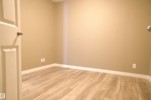 Unfurnished room with light wood-type flooring and baseboards - 104 5804 Place Nw, Edmonton, AB - Indoor Photo Showing Other Room