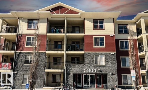 Property at dusk featuring a view of apartment building / complex - 104 5804 Place Nw, Edmonton, AB - Outdoor With Balcony With Facade