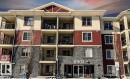 Property at dusk featuring a view of apartment building / complex - 104 5804 Place Nw, Edmonton, AB  - Outdoor With Balcony With Facade 