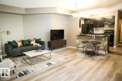 Living room featuring light wood-style floors and baseboards - 