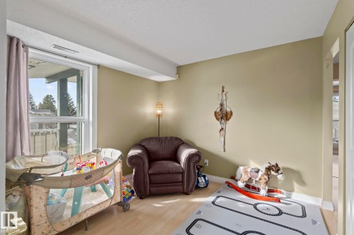 Sitting room featuring wood finished floors and a textured ceiling - 1925 Saddleback Road, Edmonton, AB - Indoor