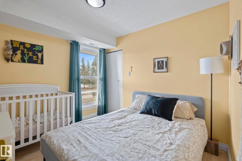Bedroom with a textured ceiling and wood finished floors - 1925 Saddleback Road, Edmonton, AB - Indoor Photo Showing Bedroom