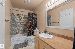 Bathroom with vanity and shower / bathtub combination with curtain - 