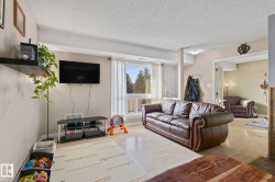 Living room with wood finished floors and a textured ceiling - 