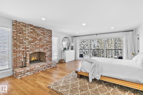 100 Wolf Willow Crescent, Edmonton, AB - Indoor Photo Showing Bedroom With Fireplace
