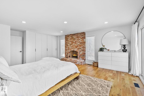 100 Wolf Willow Crescent, Edmonton, AB - Indoor Photo Showing Bedroom With Fireplace