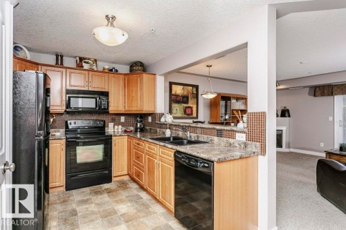325 7801 Golf Course Road, Stony Plain, AB - Indoor Photo Showing Kitchen With Double Sink