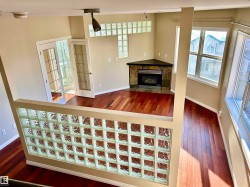 Unfurnished living room featuring dark wood finished floors and a tiled fireplace - 