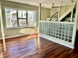 Stairway with hardwood / wood-style flooring and baseboards - 