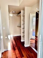 Walk in closet with dark wood-type flooring - 