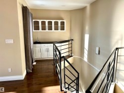 Stairs featuring hardwood / wood-style flooring and baseboards - 