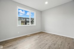 Empty room featuring light wood-style flooring and recessed lighting - 