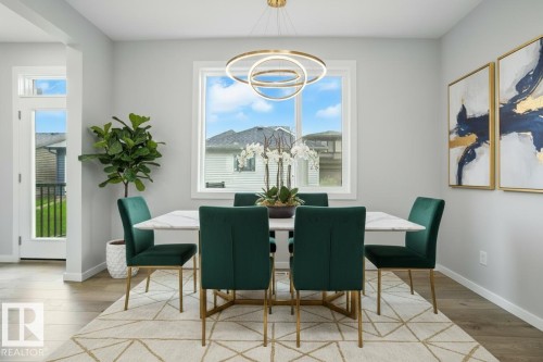 Dining space featuring light wood-type flooring and hanging lights - 20727 25 Ave, Edmonton, AB - Indoor Photo Showing Dining Room