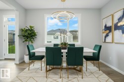 Dining space featuring light wood-type flooring and hanging lights - 