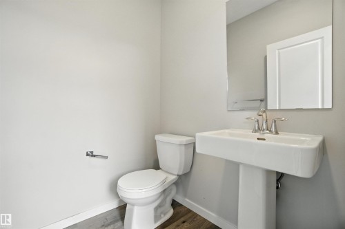 Bathroom with baseboards and dark wood-style floors - 20727 25 Ave, Edmonton, AB - Indoor Photo Showing Bathroom