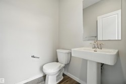 Bathroom with baseboards and dark wood-style floors - 