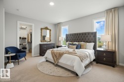 Bedroom with a spacious closet and light colored carpet - 