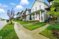 View of home's exterior featuring a residential view, board and batten siding, covered porch, and a lawn - 