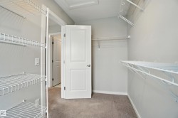 Walk in closet featuring light colored carpet - 