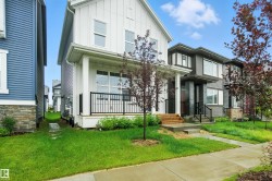 View of front facade featuring a front yard and board and batten siding - 